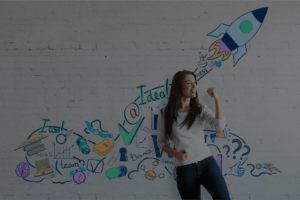 Female solopreneurs standing in front of a white wall with images from an ideation session for her business idea.