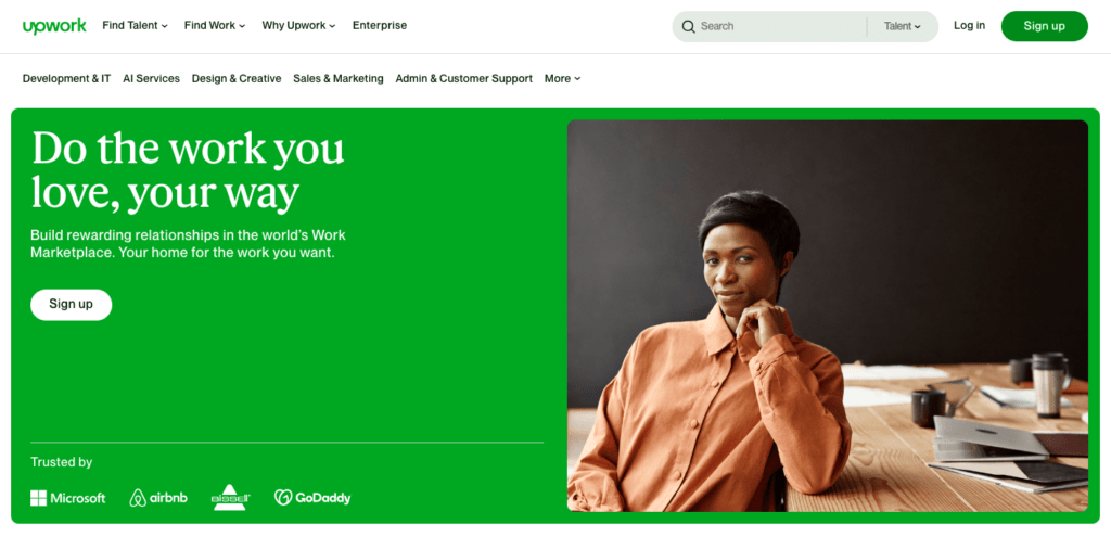 Screenshot of homepage for Upwork.com featuring a woman leaning on a desk. 